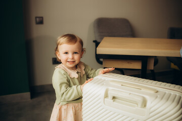 a little girl opens a suitcase