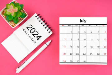 White calendar for July 2024 and pen on pink color background.