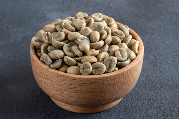 A bowl full of green coffee beans,on black background