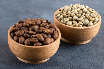 Green coffee with roasted coffee beans on black background