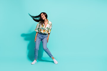 Full size photo of good mood cute woman dressed flower print blouse look empty space sale dancing isolated on turquoise color background