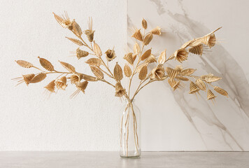 A glass vase with a bouquet of flowers made from straw on a white background. Straw weaving - Powered by Adobe