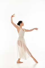 A graceful young woman in a flowing white dress expresses the beauty of movement through dance.