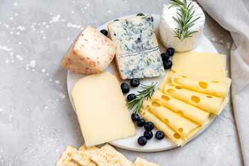 Cheese platter with craft cheese assortment  hard cheeses, mold cheese, gorgonzola, pecorino, Emmental, Roquefort