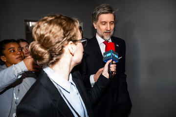 Busy republican politician walks in government building, answers press questions, gives interview...