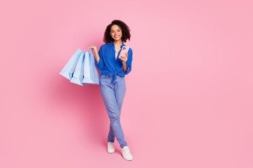 Photo of lovely charming cheerful girl dressed stylish blue clothes empty space isolated on pink...