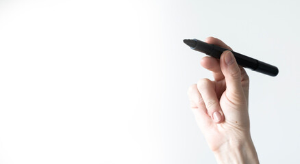 Female hand holding a black marker.isolate on a white background banner, copy space