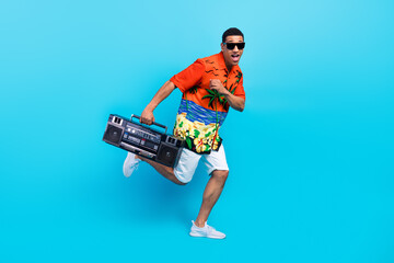 Full length photo of cool positive guy dressed print shirt enjoying boom box songs isolated blue color background