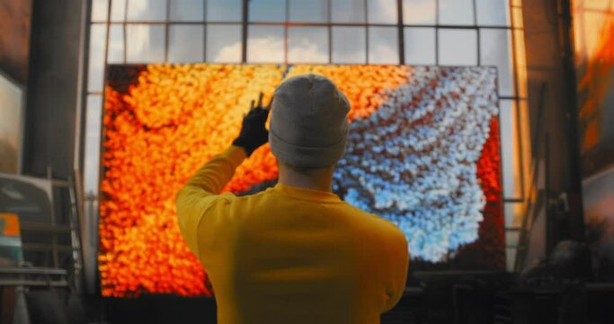 A Man In A Yellow Shirt Is Painting A Virtual Screen With Orange And Blue Colors Science Museum Video Art Motion Graphics