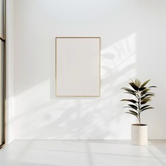 White room with a blank gold picture frame and a potted plant.