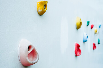 Colorful climbing holds on wall for outdoor rock climbing