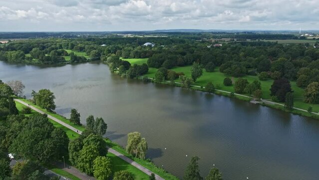 An aerial drone view of Aasee Lake in M&uuml;nster . Lake Aasee is an artificial lake located in M&uuml;nster , Germany .