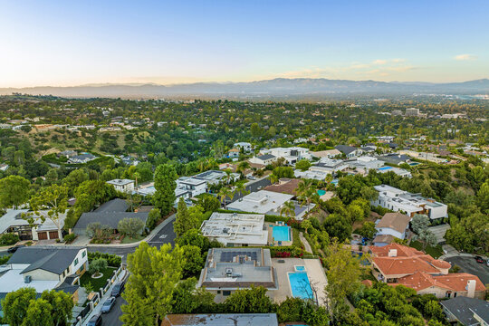 Aerial view of homes with an elevated pool above the water in California