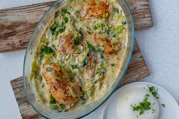 Oven baked chicken breast with delicious leek sauce in a casserole dish