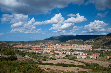 Fototapeta na wymiar Scenic view of Bosa nestled among majestic mountains. Sardinia, Italy