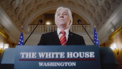 New President of the United States smiles and gestures during press campaign in the White House....