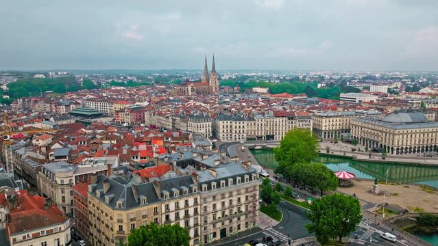 Aerial view of Bayonne city in Basque Country region by the river. Narrow medieval streets and red rooftop buildings. Twin towers rise from hilltop Gothic cathedral with medieval cloisters in France.