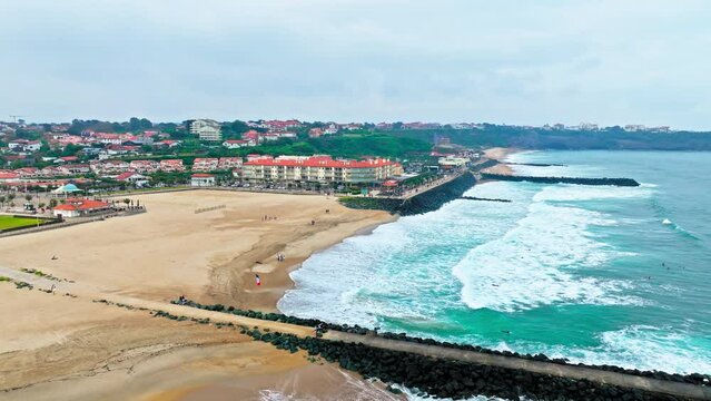 Aerial view of the historic surfing Biarritz sandy beach on a rocky cliff with sweeping ocean. An elegant seaside town in southwestern France Basque coast, a popular resort since European royalty. 