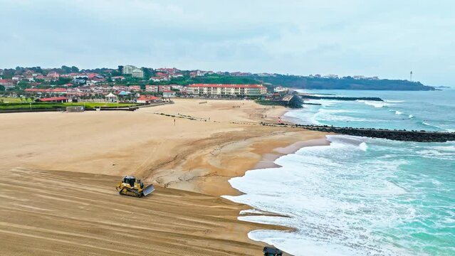 Aerial view of the historic surfing Biarritz sandy beach on a rocky cliff with sweeping ocean. An elegant seaside town in southwestern France Basque coast, a popular resort since European royalty. 
