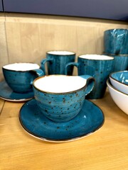 Blue different cups and saucers in a dish store.