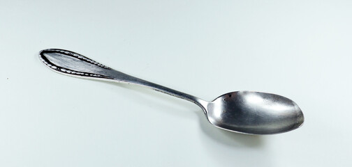 Antique vintage retro silver spoon isolated on white close-up 