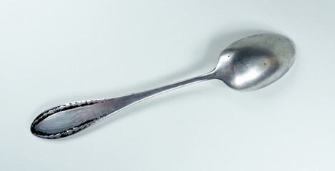 Antique vintage retro silver spoon isolated on white close-up