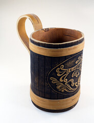 Decorative beer mug made of birch bark with the image of a fish, isolated on white close-up