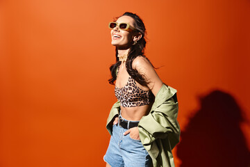 A fashionable woman wearing a leopard print top and denim shorts, exuding confidence and style on...