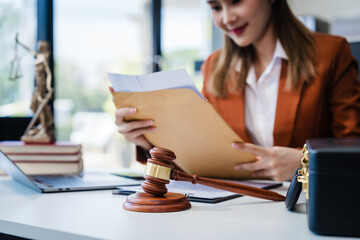 In Asian legal compliance, faculty of law, legal counseling office, a female lawyer reads a contract, advising on legal matters. clients, ensuring agreements align with laws and regulations, online