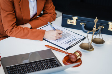 In Asian legal compliance, faculty of law, legal counseling office, a female lawyer reads a contract, advising on legal matters. clients, ensuring agreements align with laws and regulations, online