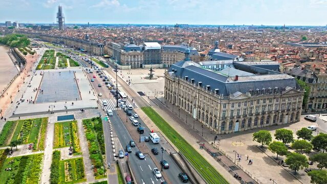Aerial view of Iconic city square architecture in Bordeaux, France. French Historical landmark Place de la Bourse and Towering Romanesque cathedral Cath&eacute;drale Saint-Andr&eacute; de Bordeaux in France.
