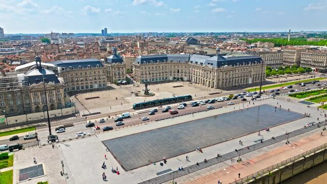 Aerial view of Iconic city square architecture in Bordeaux, France. French Historical landmark Place de la Bourse and Towering Romanesque cathedral Cath&eacute;drale Saint-Andr&eacute; de Bordeaux in France.
