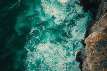 This photo captures the expansive view of a body of water situated beside a towering cliff, A top-down view of green sea waves washing over rocky ledges, AI Generated