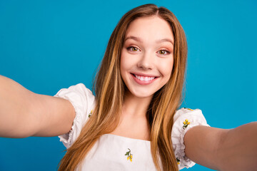 Photo of happy girl smiling make selfie isolated blue color background