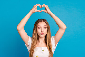 Photo of girl show heart shape sign send air kiss isolated blue color background