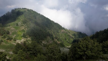 Fototapeta na wymiar Misty mountain landscape with lush greenery, Pir Chinasi Kashmir, Pakistan