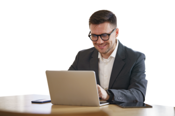 The manager is a positive man in a suit using a laptop.