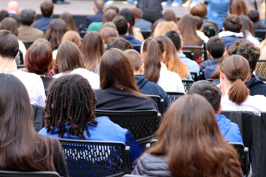 Group of teenagers sitting from behind during a demonstration