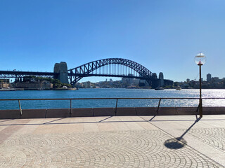 Sydney Harbour Bridge from a pedestrian walkway with an old lamppost. Arch bridge structure from a public sidewalk in Australia.