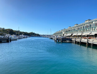 View of the port with moored boats. Apartments in rows near a marina dock. Buildings and a quay in a harbour district.