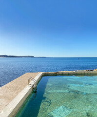 Public swimming pool near the ocean. Tidal pool. Rock Pool. Landscape, shore and view of the coast.