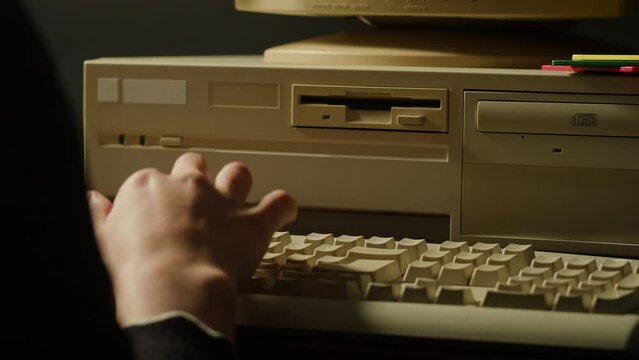 Using diskette FDD for old computer close-up. Hand inserting and ejecting Floppy Disk into vintage PC. Music recorder, playing retro computer games. 