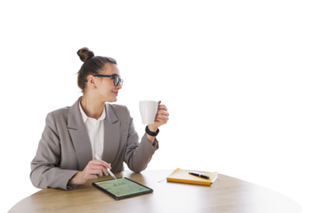 A young female consultant uses a tablet and drinks a coffee break. Isolated background.