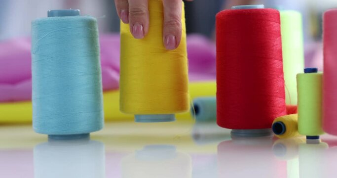 Multi-colored threads and fabrics in workplace. Accessories for work in the studio concept