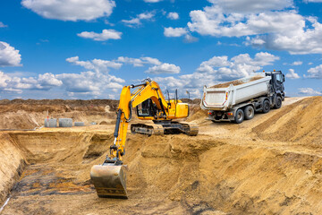  excavator is working and digging at construction site - 782179404