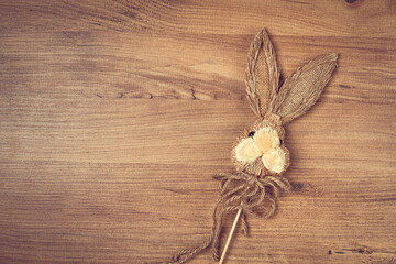 Easter bunny made of straw, on a wooden background, top view, no people,