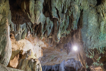 Lime stone stalactites in the cave - mineral formation that hangs from the cave's ceiling