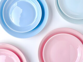 Top view , Pink, Blue, and light Blue pastel coloured plates on white background 