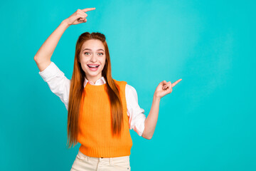Photo portrait of pretty young girl point shocked empty space wear trendy orange knitwear outfit...