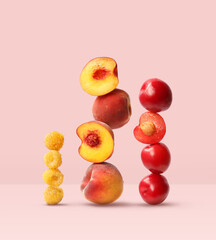 Creative layout made of plum, peach and raspberry on the pink background. Food concept. Macro concept.